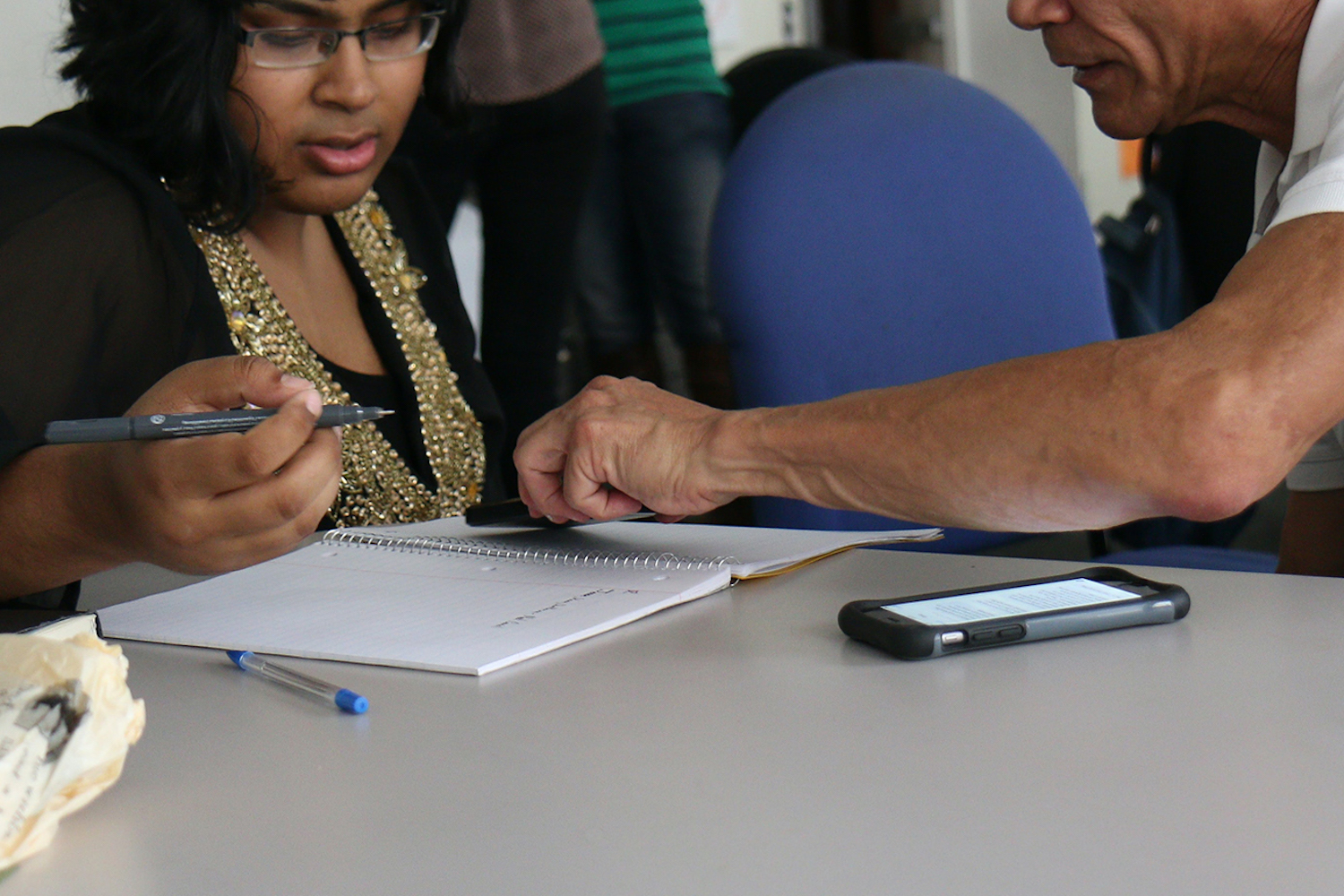 A man supporting a woman with writing