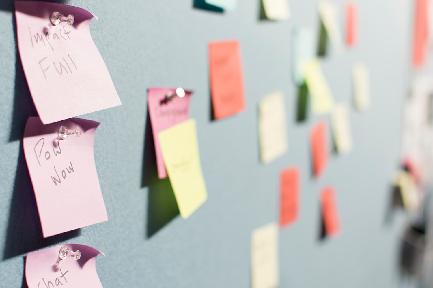 Lots of sticky notes pinned to a board
