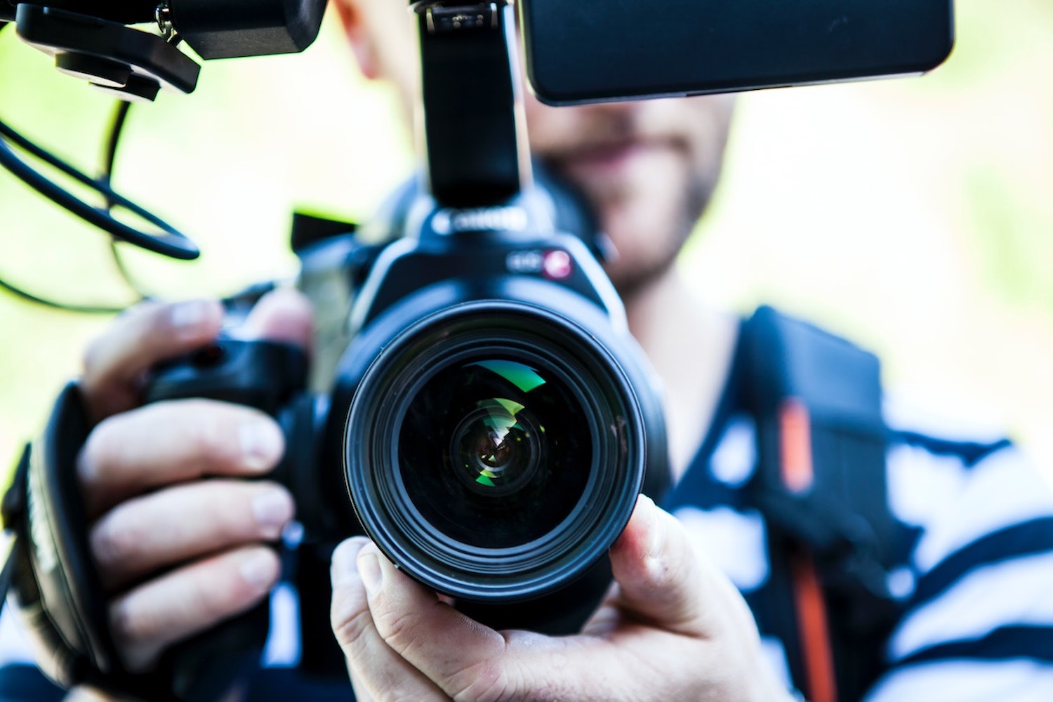 A man pointing a video camera