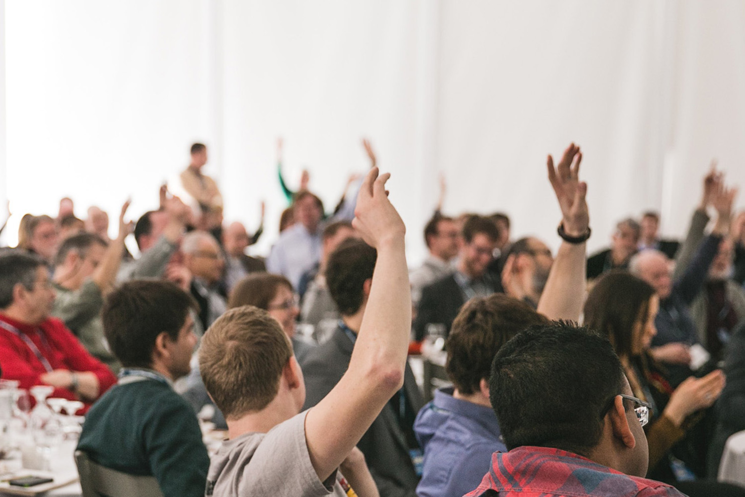 A large group of people with their hands up