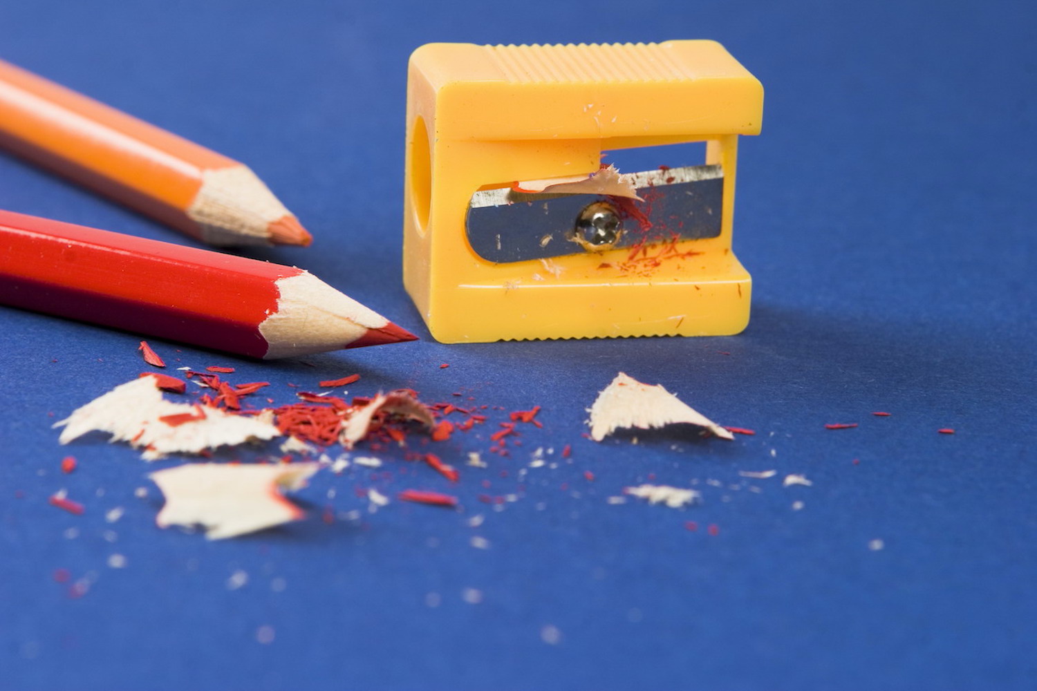 Two coloured pencils and a pencil sharpener