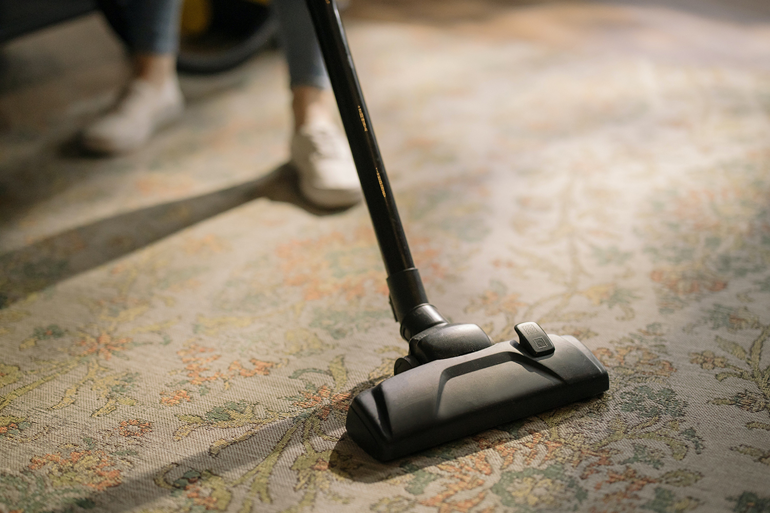 A woman vacuuming the carpet