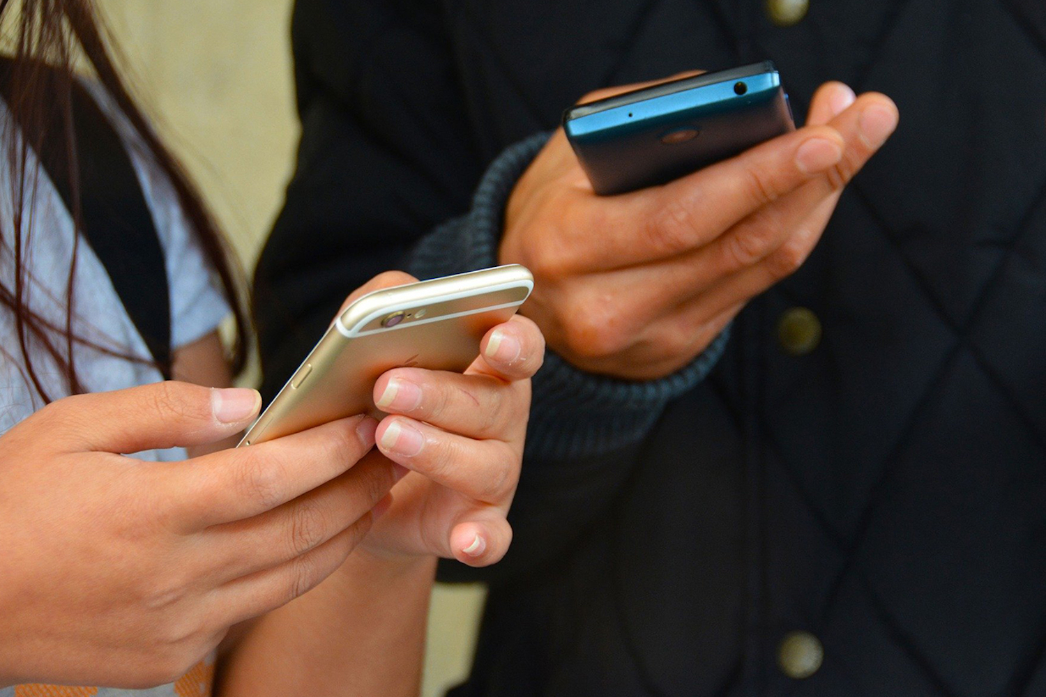A man and a woman using their mobile phones