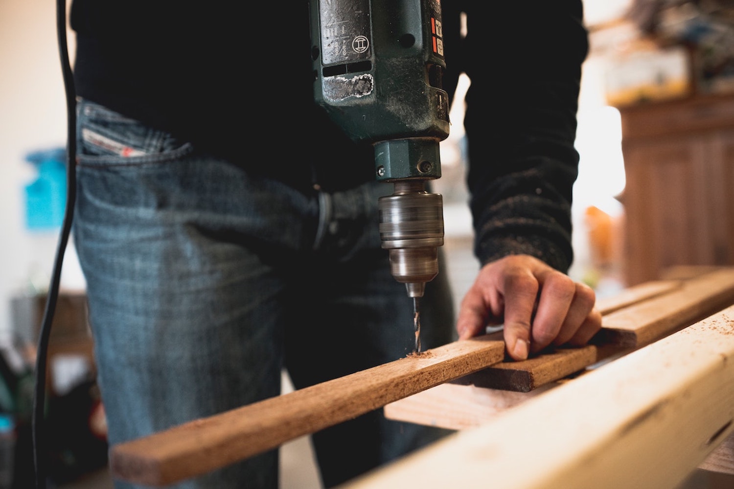 A man drilling some wood
